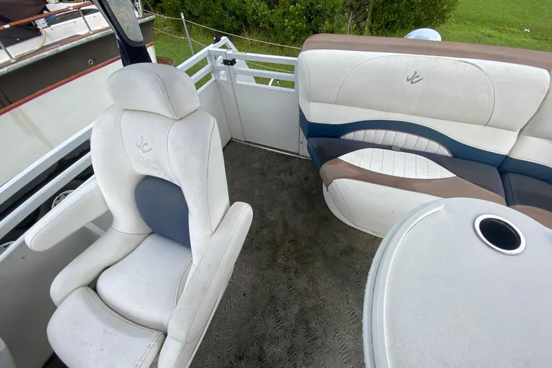 Slide: The Image of Interior of a 2010 JC NEPTOON 19 boat with white seating and table. - 14