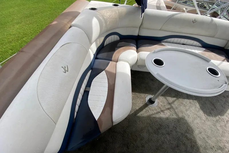 Slide: The Image of 2010 JC NEPTOON 19 boat interior with cushioned seating and table. - 12