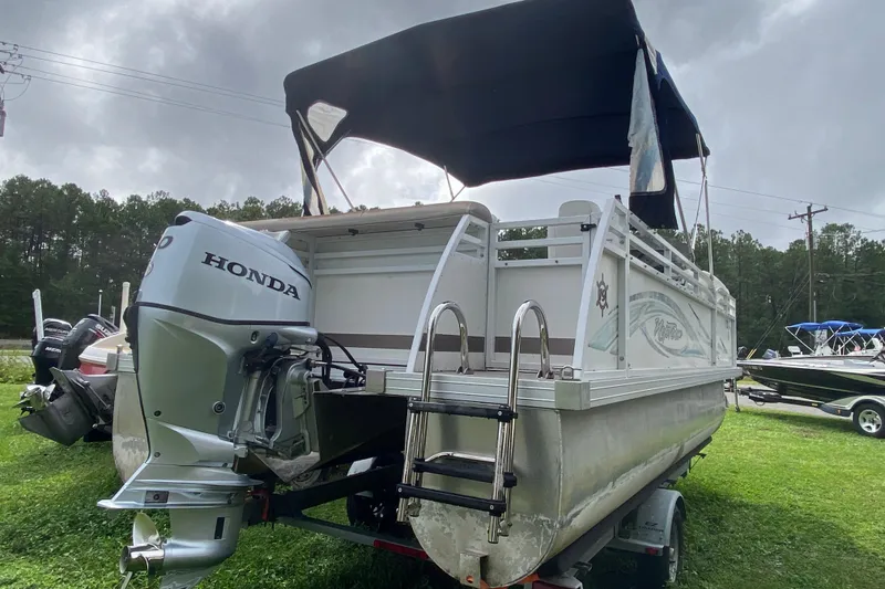 Slide: The Image of Pontoon boat JC NEPTOON 19, 2010 model, with Honda outboard motor, parked on grass. - 3