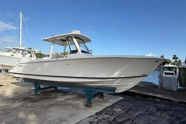 Slide: The Image of 2025 Pursuit S 288 Sport boat on display near waterfront. - 1