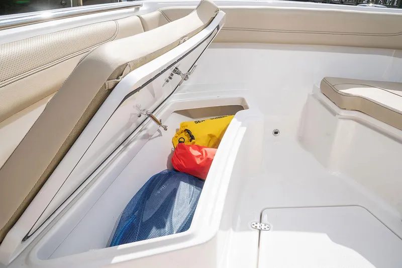 Slide: The Image of Manufacturer Provided Image: 2025 Pursuit S 288 Sport boat storage compartment with gear inside. - 14