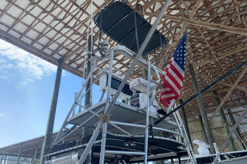 Slide: The Image of 1974 Bertram 31 Flybridge Cruiser with American flag in covered dock. - 10