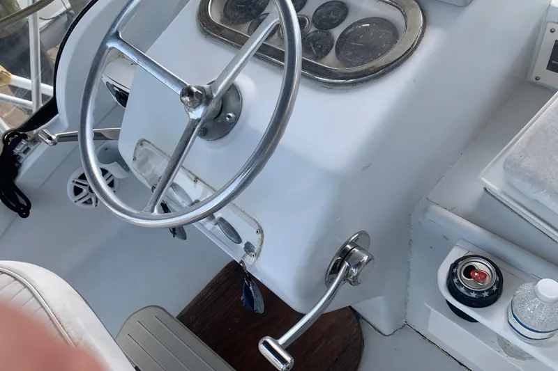 Slide: The Image of 1974 Bertram 31 Flybridge Cruiser helm with steering wheel and control panel. - 15