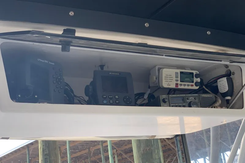 Slide: The Image of 1974 Bertram 31 Flybridge Cruiser electronics panel with GPS, radio, and navigation equipment. - 19