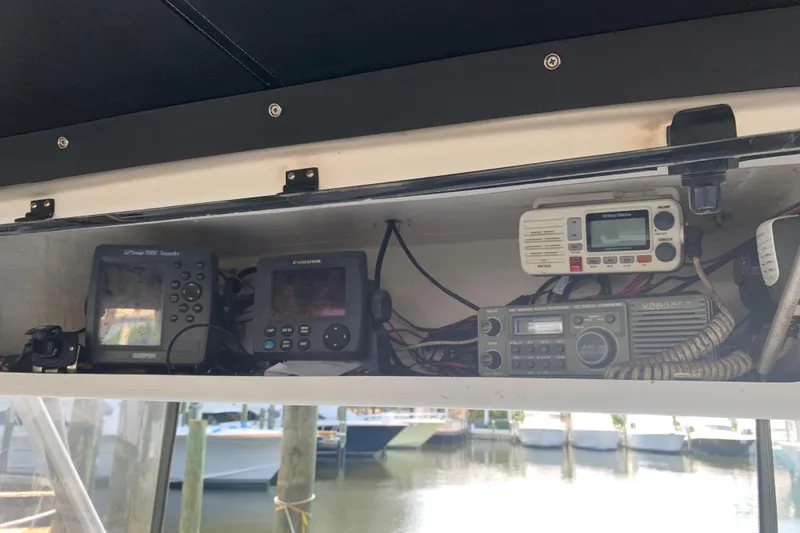Slide: The Image of 1974 Bertram 31 Flybridge Cruiser electronics panel with navigation and communication devices. - 20