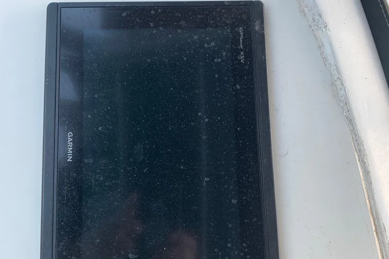 Slide: The Image of Garmin GPS device on 1974 Bertram 31 Flybridge Cruiser, dusty screen. - 24