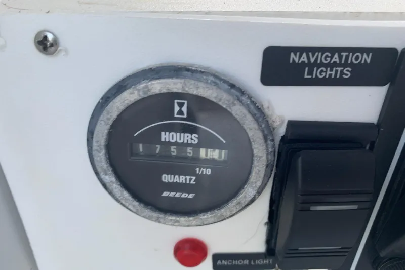Slide: The Image of Hour meter and navigation lights on 1974 Bertram 31 Flybridge Cruiser dashboard. - 25