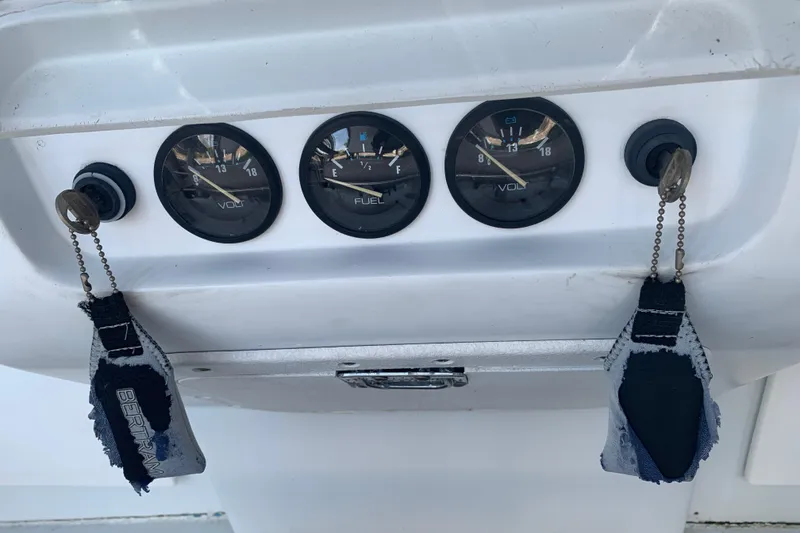 Slide: The Image of 1974 Bertram 31 Flybridge Cruiser dashboard with volt and fuel gauges. - 27