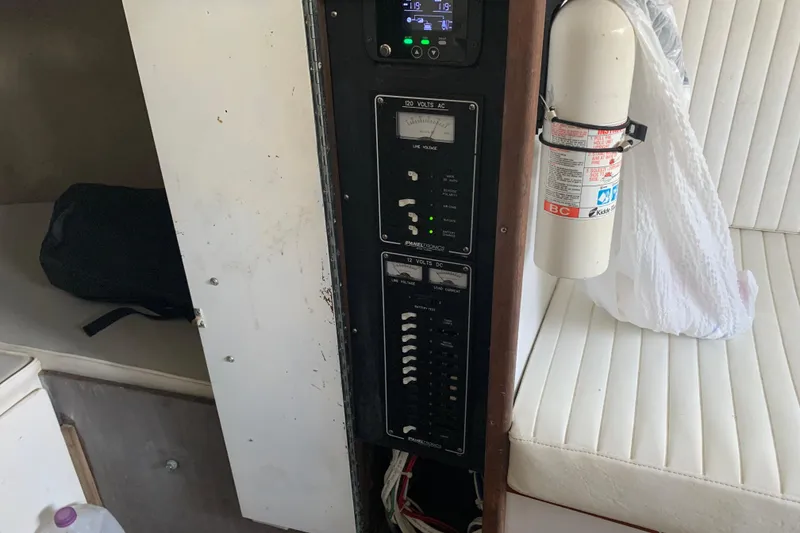 Slide: The Image of Electrical panel and fire extinguisher inside a 1974 Bertram 31 Flybridge Cruiser. - 46