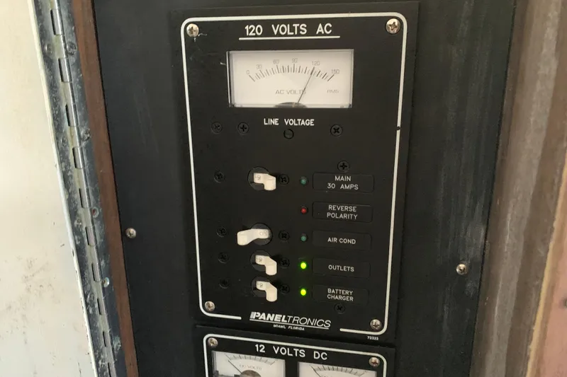 Slide: The Image of Electrical panel on a 1974 Bertram 31 Flybridge Cruiser, showing 120 volts AC controls. - 48
