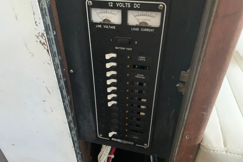 Slide: The Image of Electrical panel of a 1974 Bertram 31 Flybridge Cruiser, showing voltage and current meters. - 49