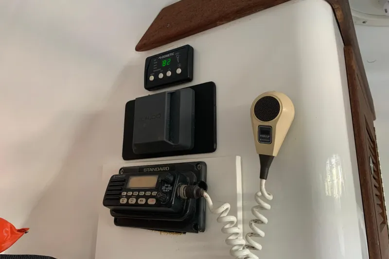 Slide: The Image of Interior electronics of a 1974 Bertram 31 Flybridge Cruiser, featuring communication and control devices. - 50