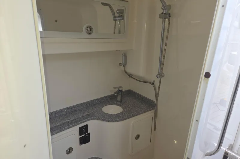 Slide: The Image of 2019 Concept 44' Cuddy Cabin bathroom with shower, sink, and storage cabinets. - 26