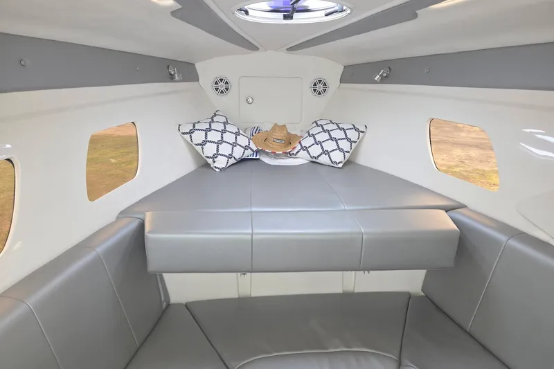 Slide: The Image of Interior of 2019 Concept 44' Cuddy Cabin with modern seating and decorative pillows. - 24