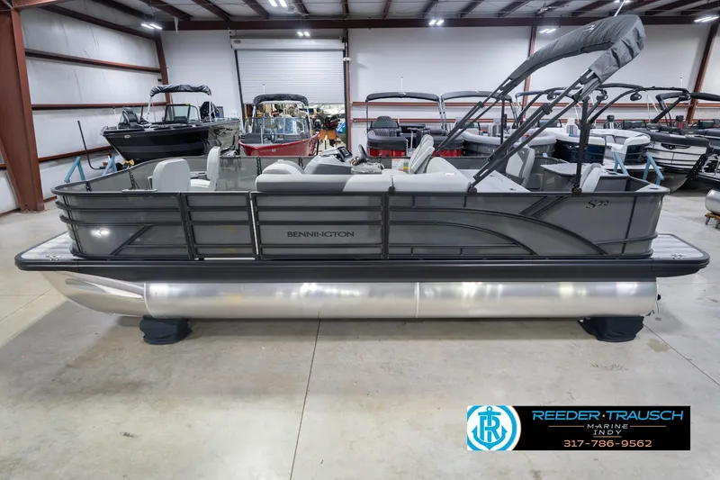 The Image of 2026 Bennington 22 SF pontoon boat in showroom, featuring sleek design and spacious seating. - 0