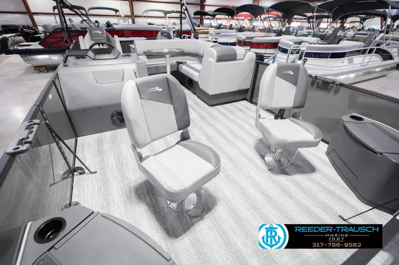 Slide: The Image of 2026 Bennington 22 SF boat interior with gray seating and modern design in showroom. - 13