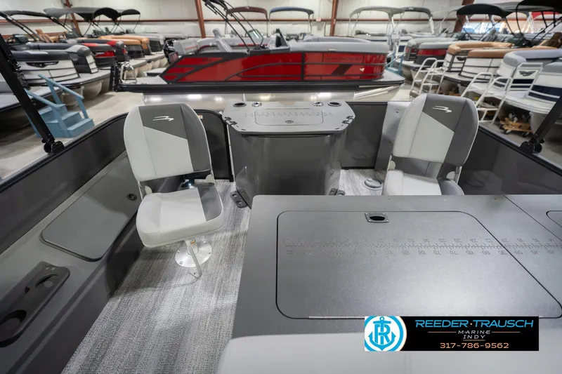 Slide: The Image of 2026 Bennington 22 SF boat interior with seating and console, displayed in showroom. - 18