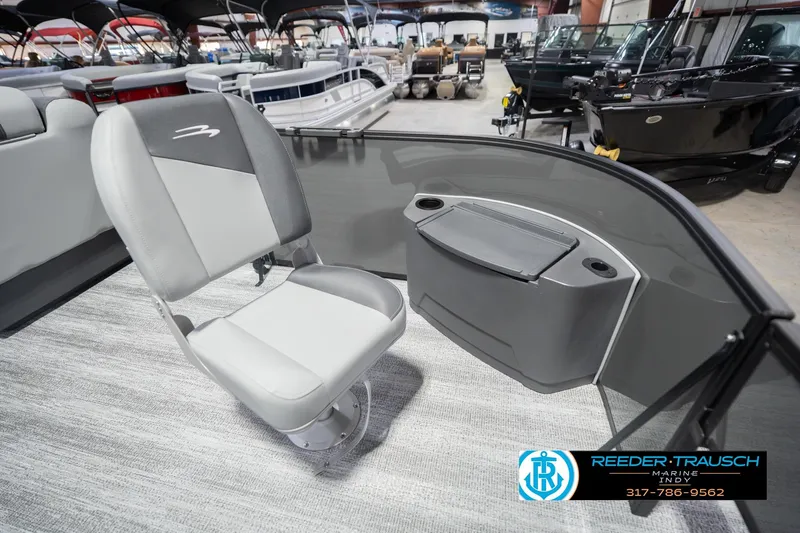 Slide: The Image of 2026 Bennington 22 SF boat interior with gray seating and storage compartment. - 22