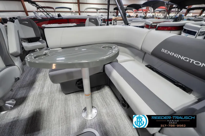 Slide: The Image of 2026 Bennington 22 SF boat interior with gray seating and table, showroom display. - 25
