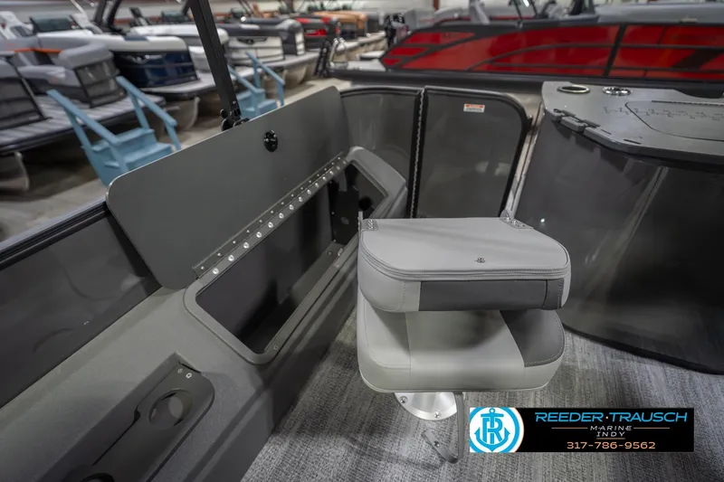 Slide: The Image of 2026 Bennington 22 SF boat interior with gray seating and storage, displayed at Reeder Trausch Marine. - 35