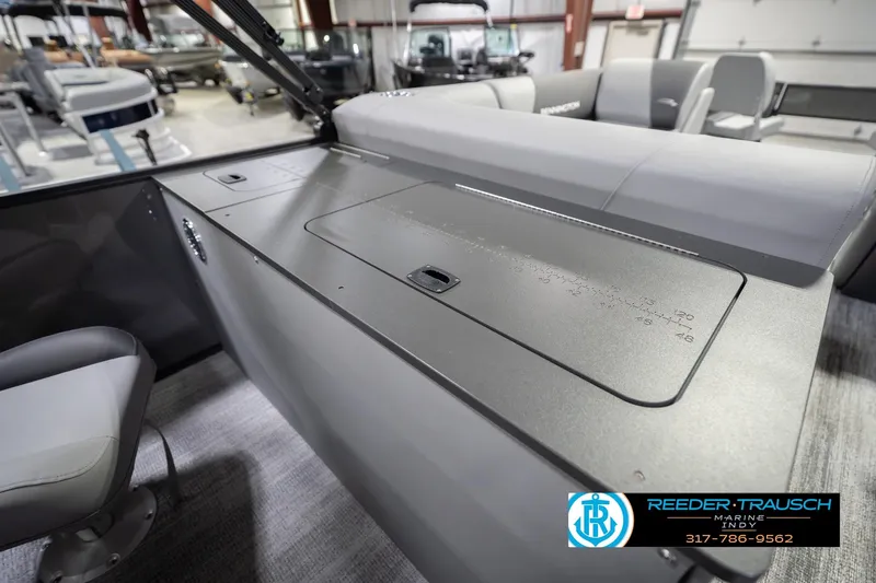 Slide: The Image of 2026 Bennington 22 SF boat interior with seating and control panel in showroom. - 36