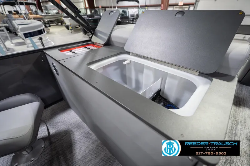 Slide: The Image of 2026 Bennington 22 SF boat interior with open storage compartment in showroom. - 37