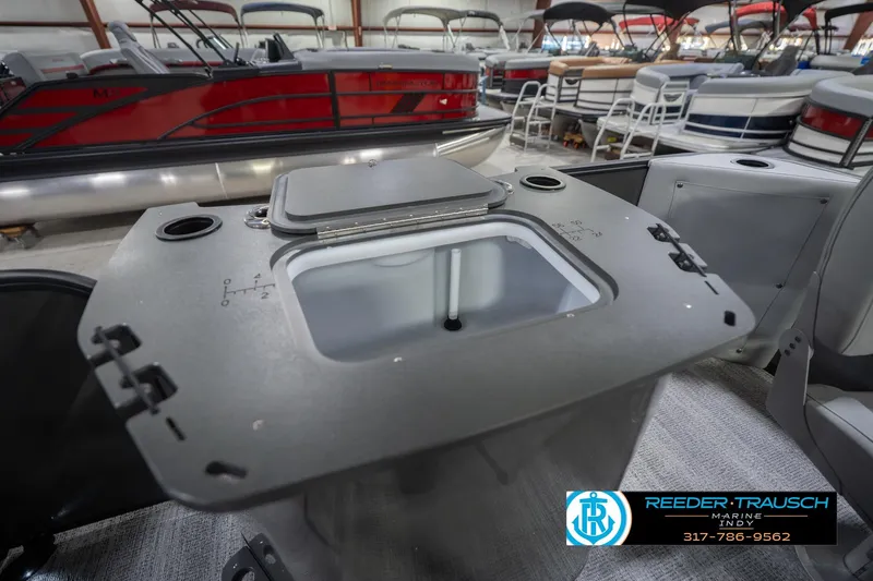 Slide: The Image of 2026 Bennington 22 SF pontoon boat interior with storage compartment, displayed at Reeder-Trausch Marine. - 39