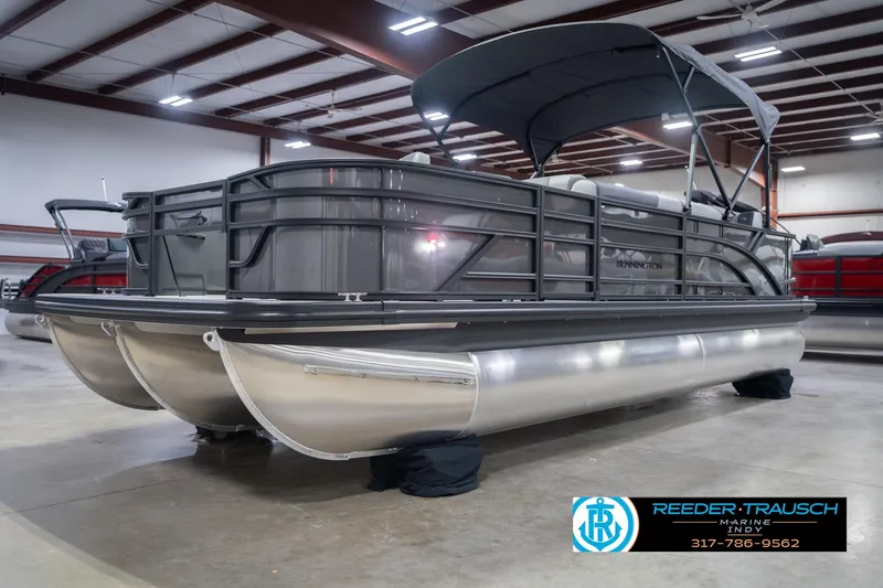 Slide: The Image of 2026 Bennington 22 SF pontoon boat in showroom with canopy and sleek design. - 4