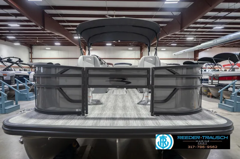 Slide: The Image of 2026 Bennington 22 SF pontoon boat in showroom, featuring sleek design and spacious deck. - 5