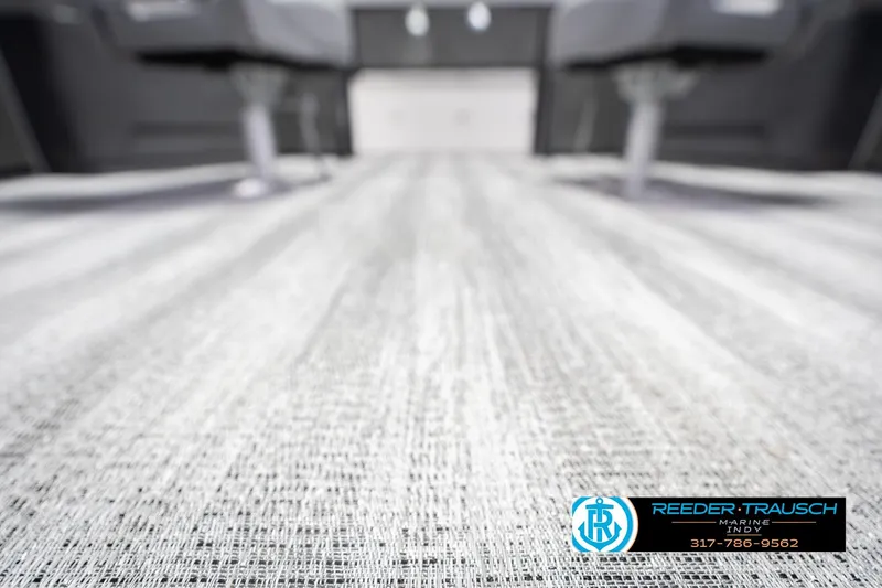 Slide: The Image of 2026 Bennington 22 SF boat interior flooring, featuring textured design and Reeder Trausch Marine logo. - 55