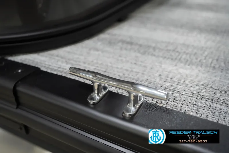 Slide: The Image of 2026 Bennington 22 SF boat cleat on textured deck, Reeder Trausch Marine logo visible. - 60