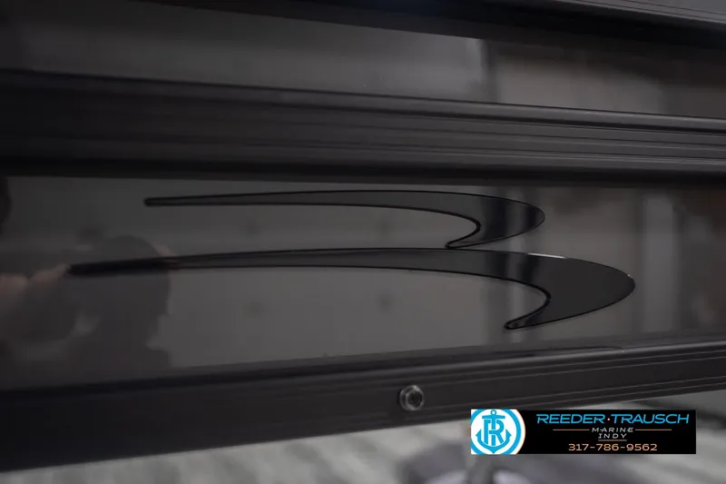 Slide: The Image of 2026 Bennington 22 SF boat detail with sleek black design and Reeder-Trausch Marine logo. - 62