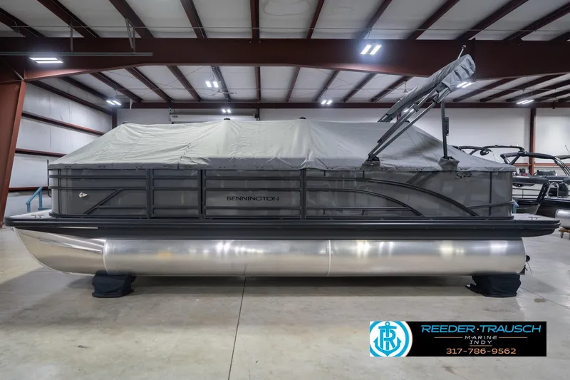 Slide: The Image of 2026 Bennington 22 SF pontoon boat covered in storage facility. - 65