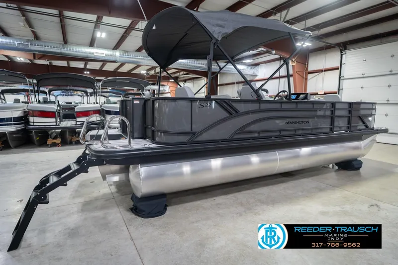 Slide: The Image of 2026 Bennington 22 SF pontoon boat in showroom with canopy and ladder. - 8