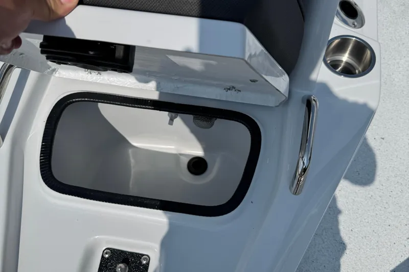 Slide: The Image of Open storage compartment on 2026 Xpress H20B Bay boat with cup holders. - 4