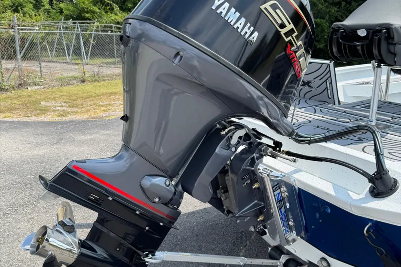 Slide: The Image of 2026 Xpress H20B Bay boat with Yamaha outboard motor, parked outdoors. - 7