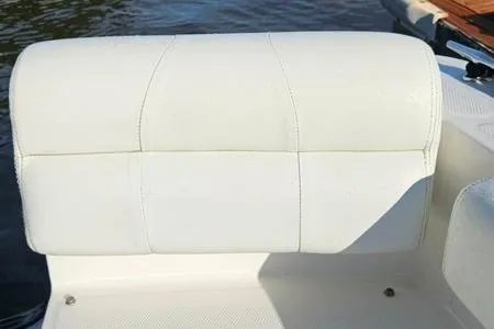 Slide: The Image of 2021 Edgewater 188CC boat seat with white upholstery near water. - 10