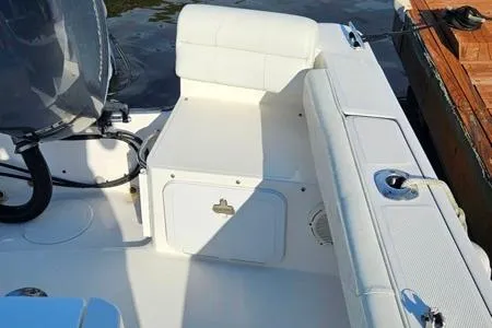 Slide: The Image of 2021 Edgewater 188CC boat interior with white seating and storage compartments. - 18