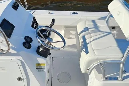 Slide: The Image of 2021 Edgewater 188CC boat interior with steering wheel and white seating. - 20