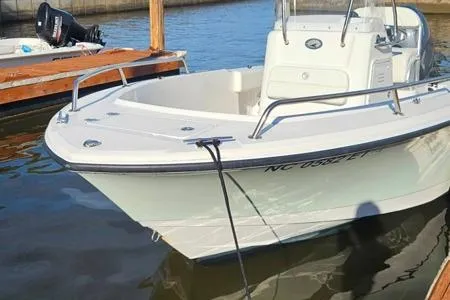 Slide: The Image of 2021 Edgewater 188CC boat docked on calm water, featuring sleek design and white exterior. - 22