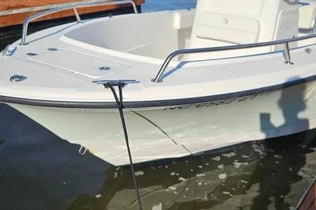 Slide: The Image of 2021 Edgewater 188CC boat docked on calm water, showcasing sleek design and sturdy build. - 26