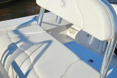 Slide: The Image of 2021 Edgewater 188CC boat interior with white cushioned seating and rod holders. - 9