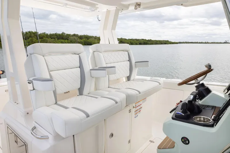 Slide: The Image of Manufacturer Provided Image: 2025 Pursuit S 328 Sport boat interior with luxurious seating and modern helm controls. - 12