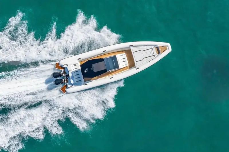 The Image of Aerial view of 2025 Technohull GTX speedboat cruising on turquoise water. - 1