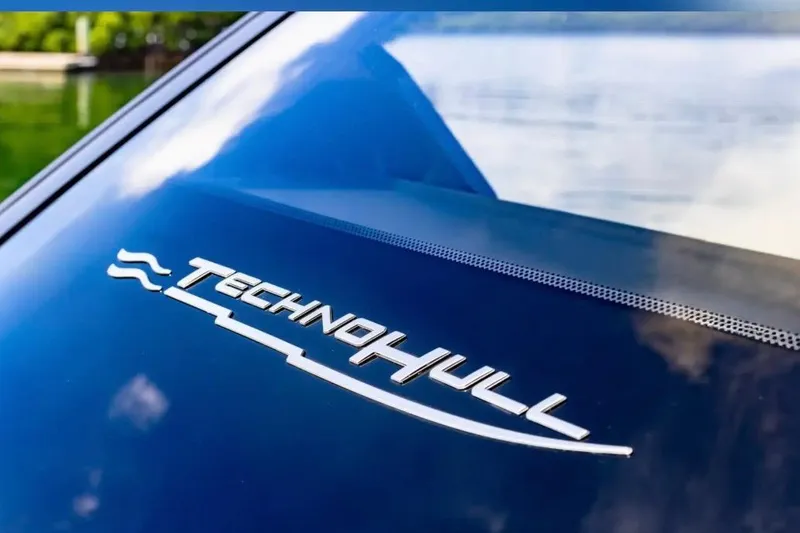 Slide: The Image of 2025 Technohull GTX logo on sleek boat surface. - 13