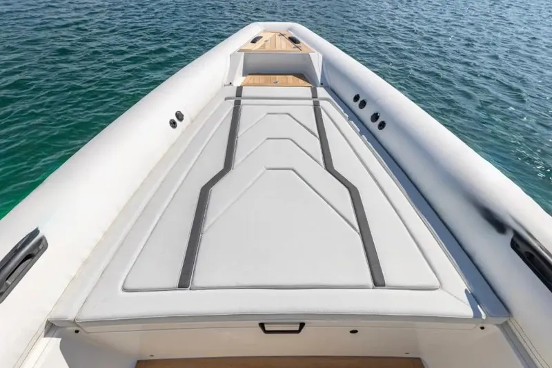 Slide: The Image of 2025 Technohull GTX boat deck with sleek design on calm water. - 15