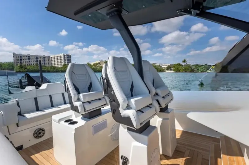 Slide: The Image of 2025 Technohull GTX boat interior with modern seating on a sunny day. - 16