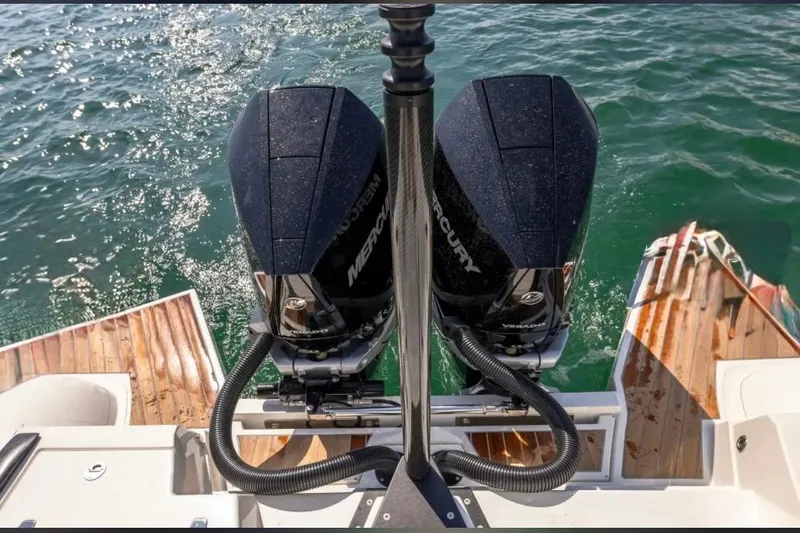Slide: The Image of Technohull GTX 2025 boat with dual Mercury outboard engines on water. - 18