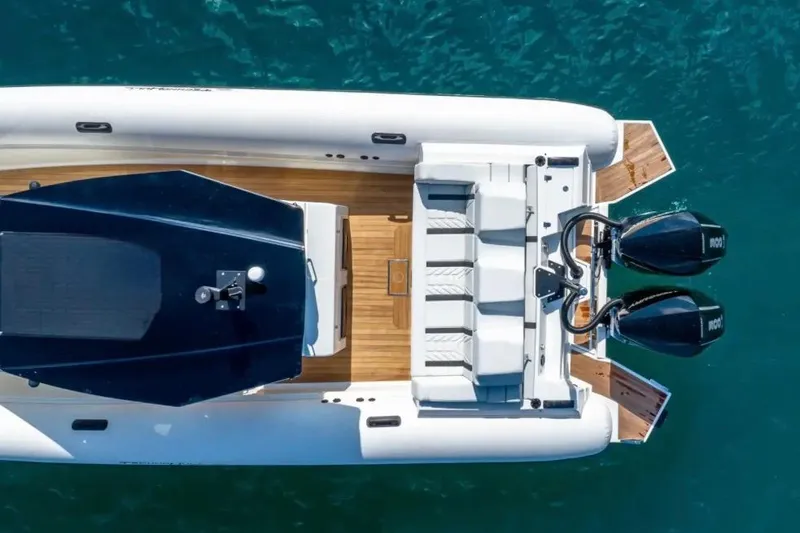 Slide: The Image of Aerial view of 2025 Technohull GTX boat with dual engines on blue water. - 4