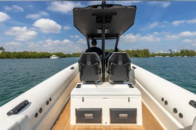 Slide: The Image of 2025 Technohull GTX boat on water, featuring dual seats and sleek design. - 7